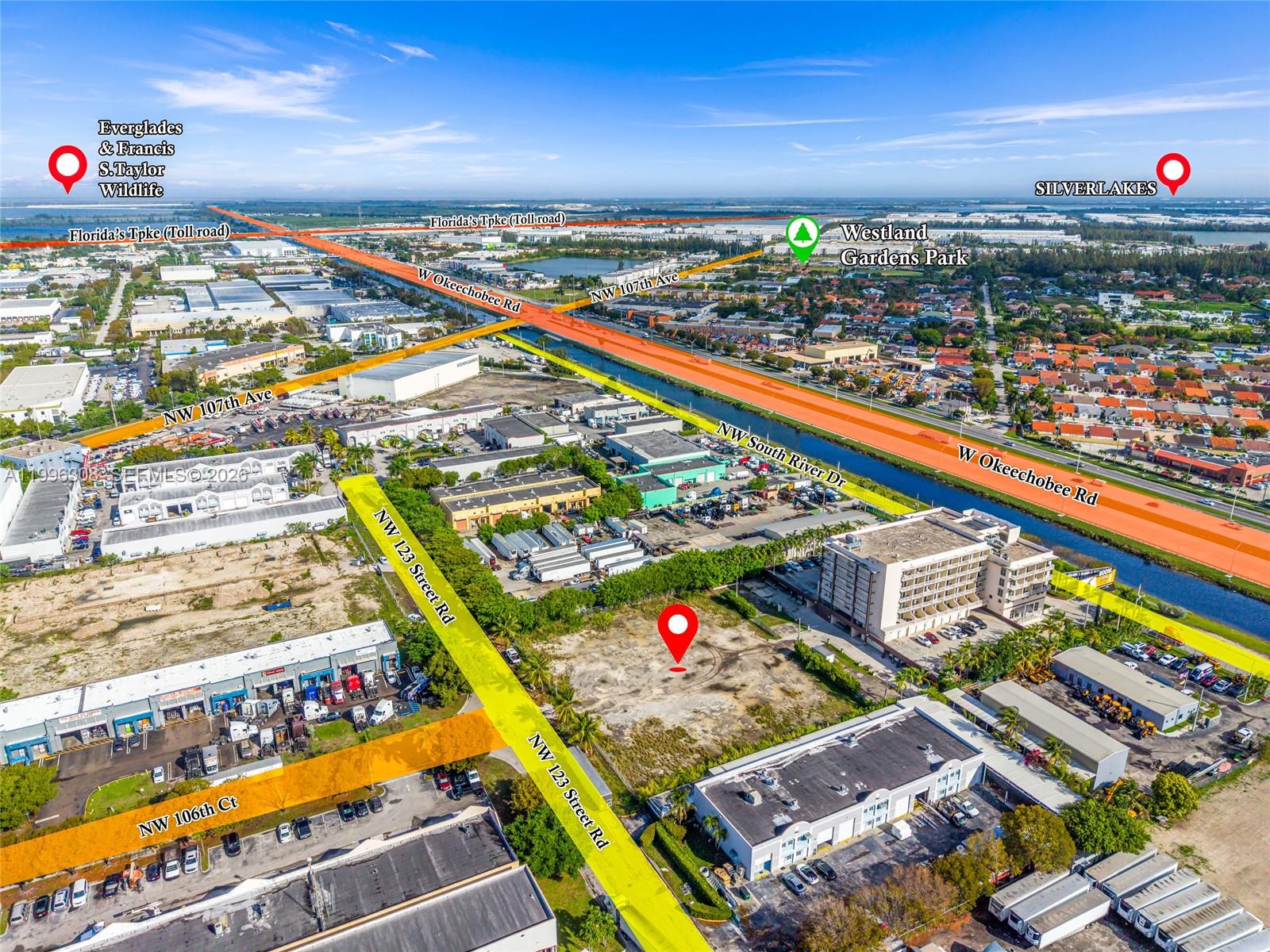 An aerial view shows a vacant lot surrounded by commercial buildings and major roadways — 10633 NW 123rd St Rd, Medley FL 33178, MEDLEY, FL