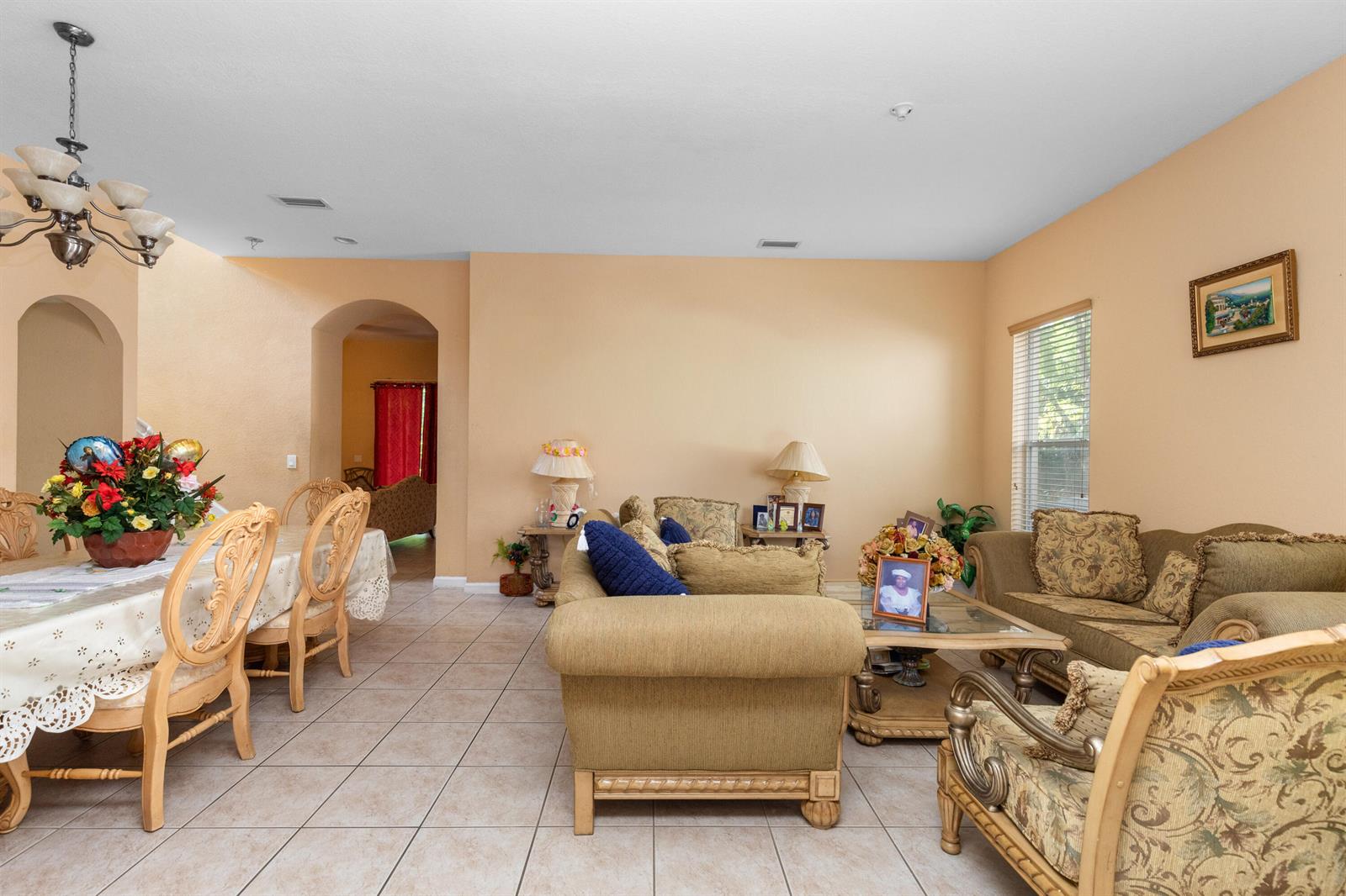 A living and dining area with tile floors, beige walls, and traditional furniture — 1017 Grove Park Circle, Boynton Beach FL 33436, BOYNTON BEACH, FL