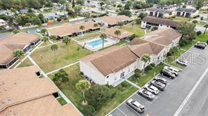 An aerial view of a multi-unit residential complex featuring a central swimming pool and parking — 1001 PLANTATION DRIVE UNIT B2, KISSIMMEE, FL