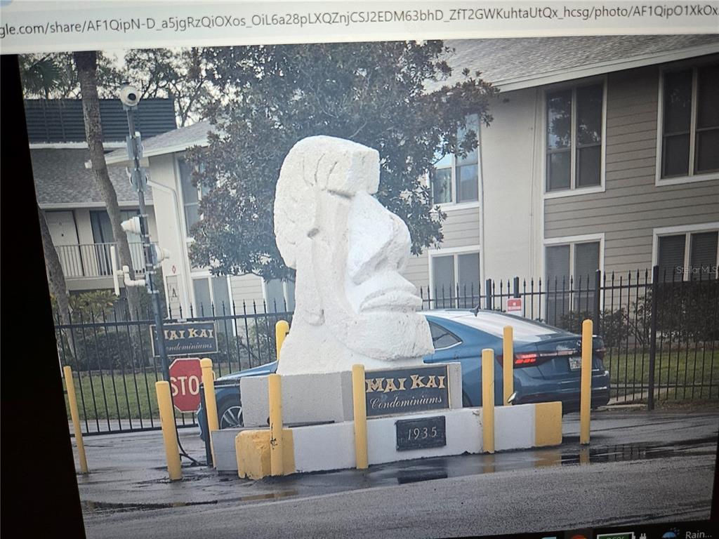A large stone Moai statue stands at the entrance of the Mai Kai Condominiums — 1935 CONWAY DRIVE UNIT 05, ORLANDO, FL