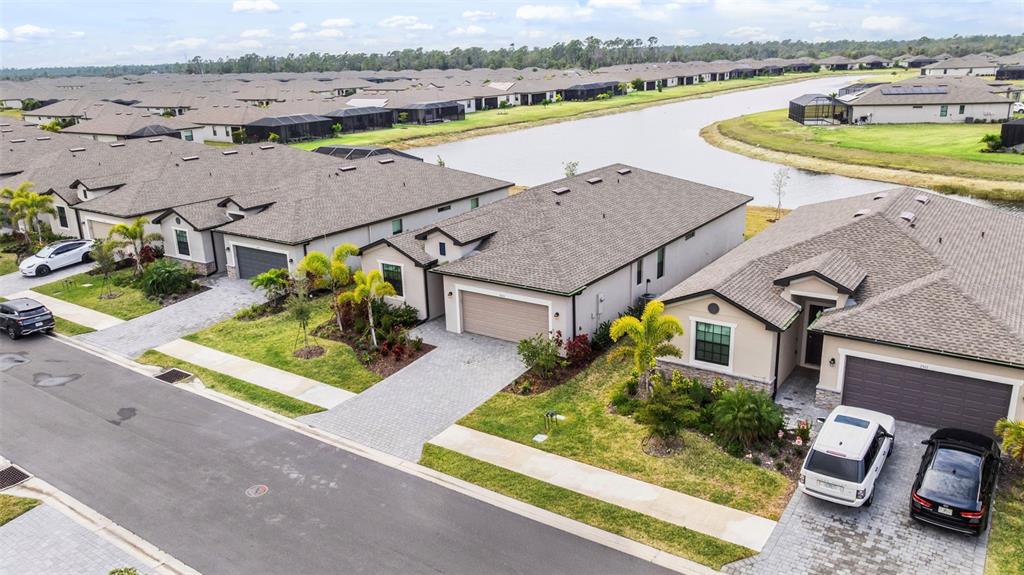 A single-story house with a beige stucco exterior, a paved driveway, and a two-car garage — 1505 SADDLEWOOD CIRCLE, PORT CHARLOTTE, FL