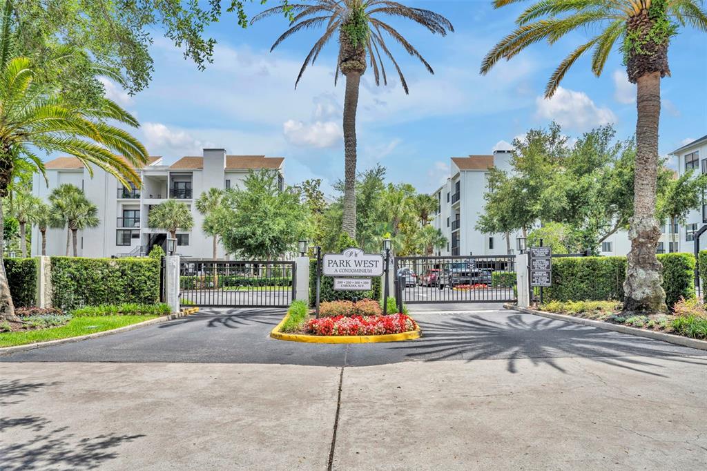 A gated entrance with a sign for Park West A Condominium and palm trees — 300 CAROLINA AVENUE UNIT 402C, WINTER PARK, FL