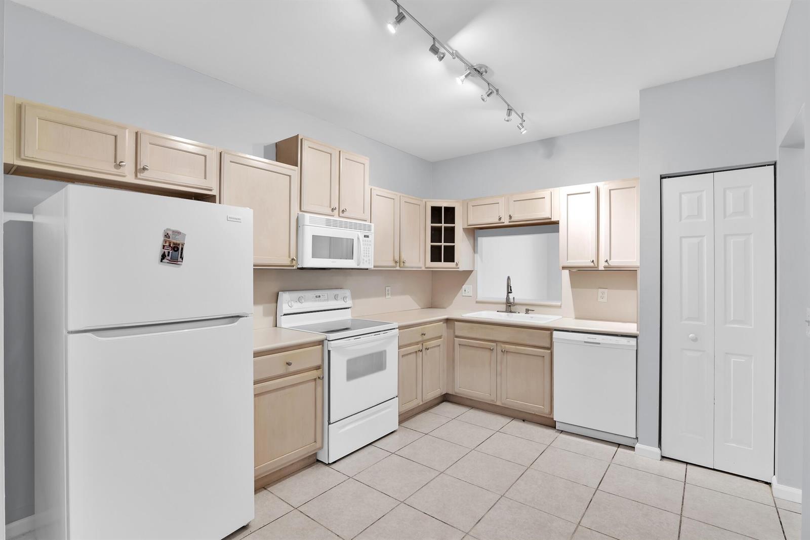 A kitchen with light wood cabinets, white appliances, tile flooring, and track lighting — 8297 Via Leonessa, Boca Raton FL 33433, BOCA RATON, FL