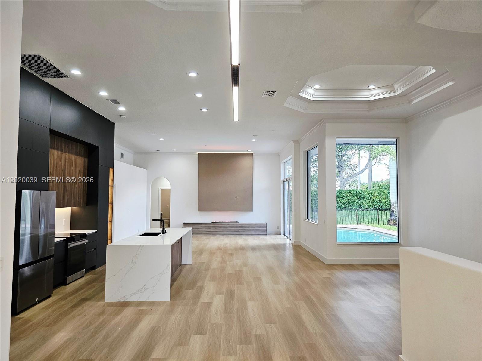 The exterior of a white house features a two-car garage and a paved driveway — 18951 SW 30th St, Miramar FL 33029, MIRAMAR, FL