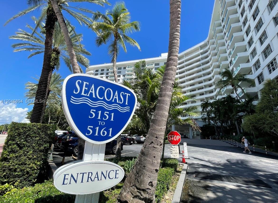 A blue sign for Seacoast stands in front of a large white apartment building — 5151 Collins Ave # 1722, Miami Beach FL 33140, MIAMI BEACH, FL