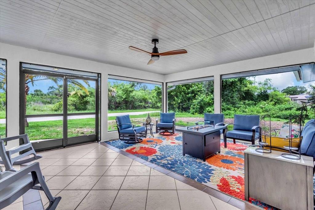 A screened-in patio with tile flooring, a ceiling fan, and outdoor furniture on a rug — 27450 SAN MARCO DRIVE, PUNTA GORDA, FL