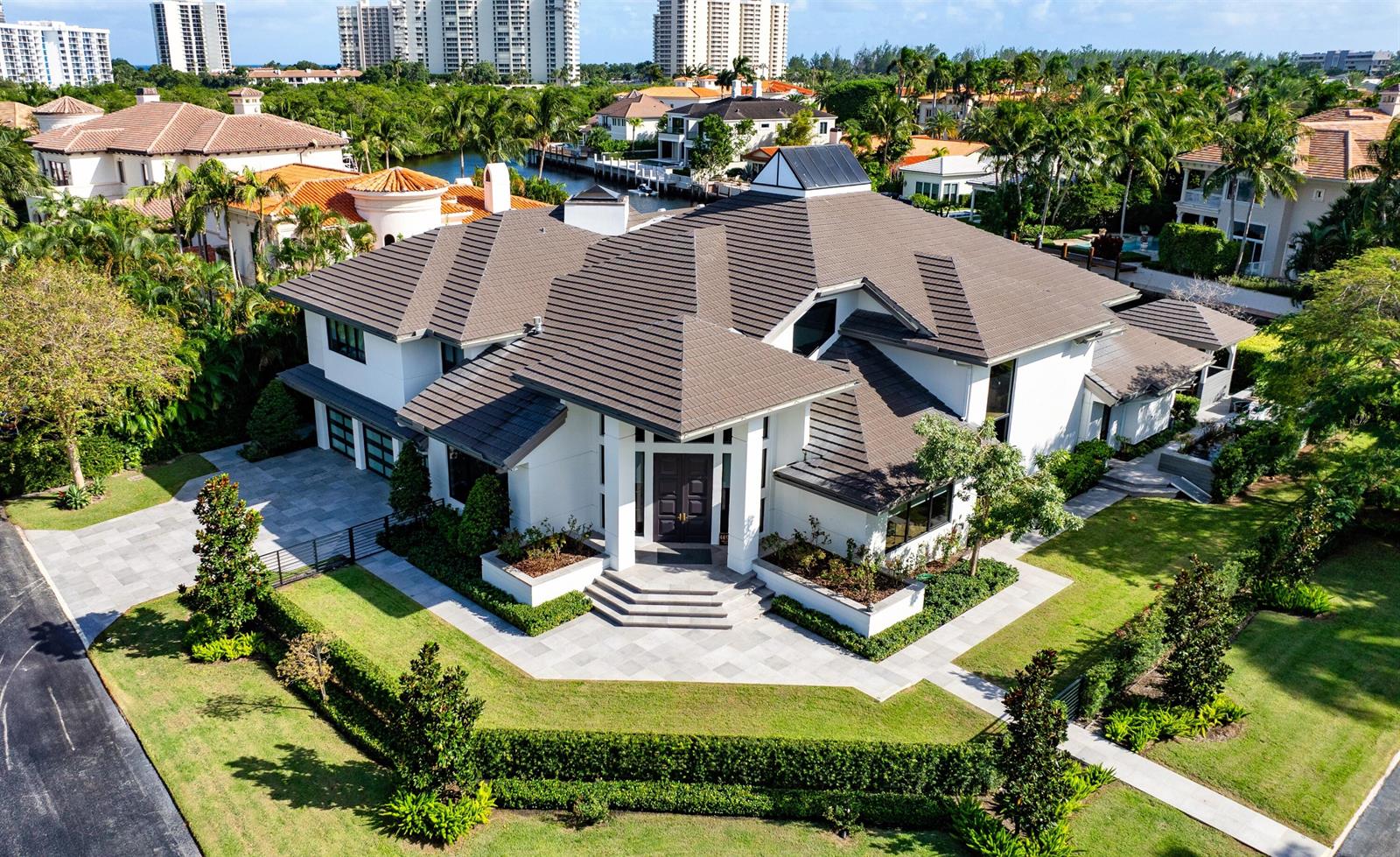 An aerial view of a white two-story house with a dark tiled roof and landscaping — 4698 Sanctuary Lane, Boca Raton FL 33431, BOCA RATON, FL