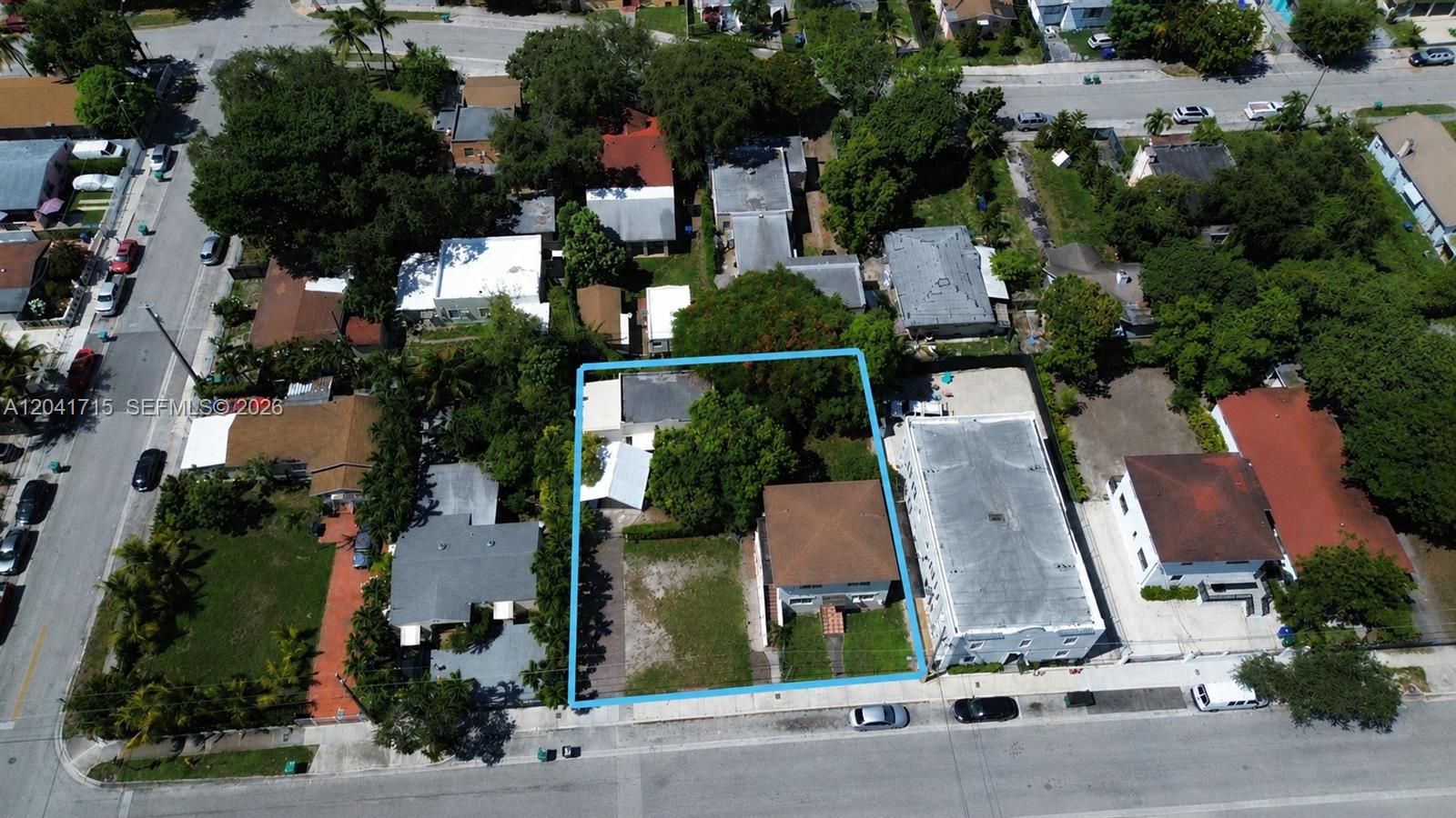 An aerial view shows a residential property lot outlined in blue with two small buildings — 255 NW 32nd St, Miami FL 33127, MIAMI, FL