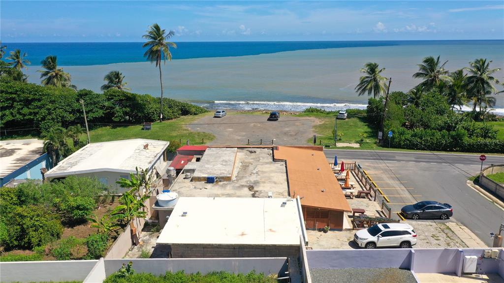 An aerial view shows a coastal building with a parking lot overlooking the ocean — Km 3.3 CARR 684, BARCELONETA, PR