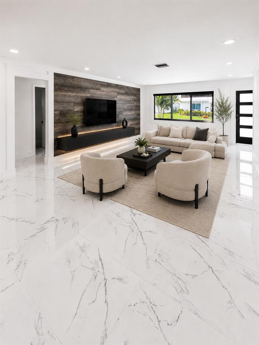 A modern living room features white marble floors, a wood-paneled accent wall, and neutral furniture — 1009 Leisure Lane, Boynton Beach FL 33426, BOYNTON BEACH, FL