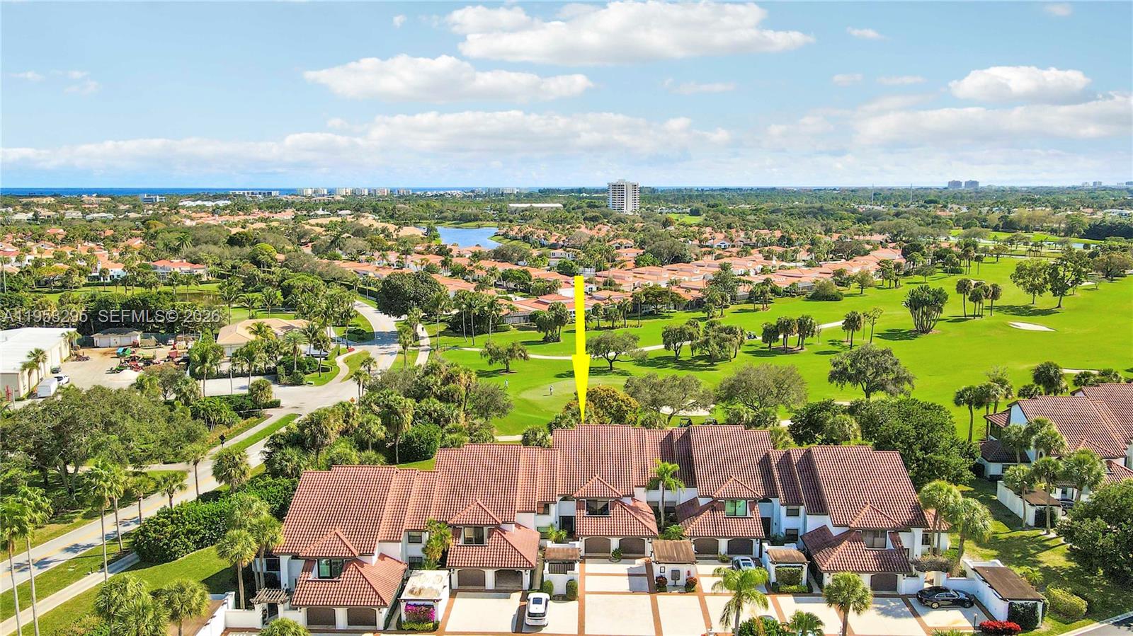 An aerial view shows a multi-unit residential building with red tile roofs near a golf course — 16600 S Traders Xing S # 253, Jupiter FL 33477, JUPITER, FL