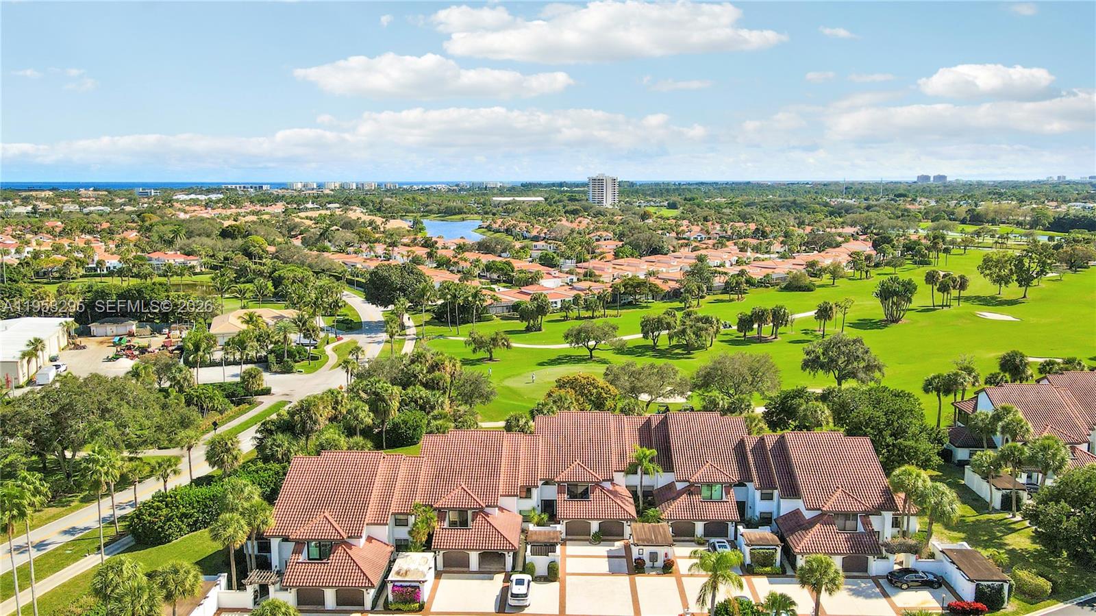 An aerial view of a residential townhouse complex situated next to a large golf course — 16600 S Traders Xing S # 253, Jupiter FL 33477, JUPITER, FL