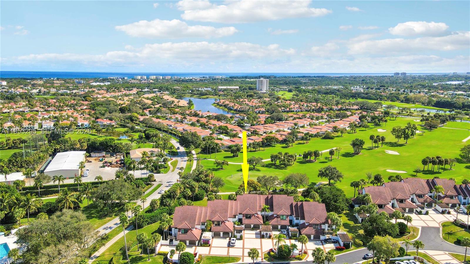 An aerial view shows a multi-unit residential building situated next to a golf course — 16600 S Traders Xing S # 253, Jupiter FL 33477, JUPITER, FL