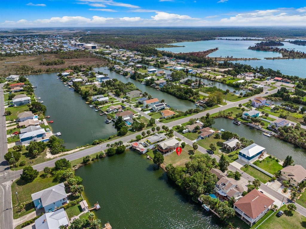 An aerial view shows a waterfront house with a red location pin — 3287 SEA GRAPE DRIVE, HERNANDO BEACH, FL