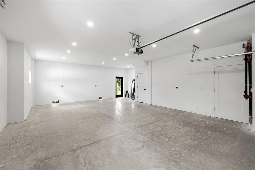 An empty garage with white walls, recessed lighting, and a concrete floor — 10351 2ND STREET N, ST PETERSBURG, FL