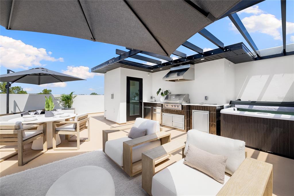 A rooftop terrace features a dining area, lounge seating, an outdoor kitchen, and a hot tub — 10351 2ND STREET N, ST PETERSBURG, FL