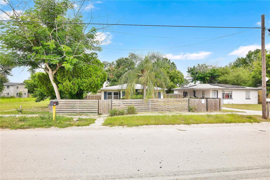 A single-story house with a wooden fence and a palm tree in the front yard — 315 E STREET, LAKE WALES, FL