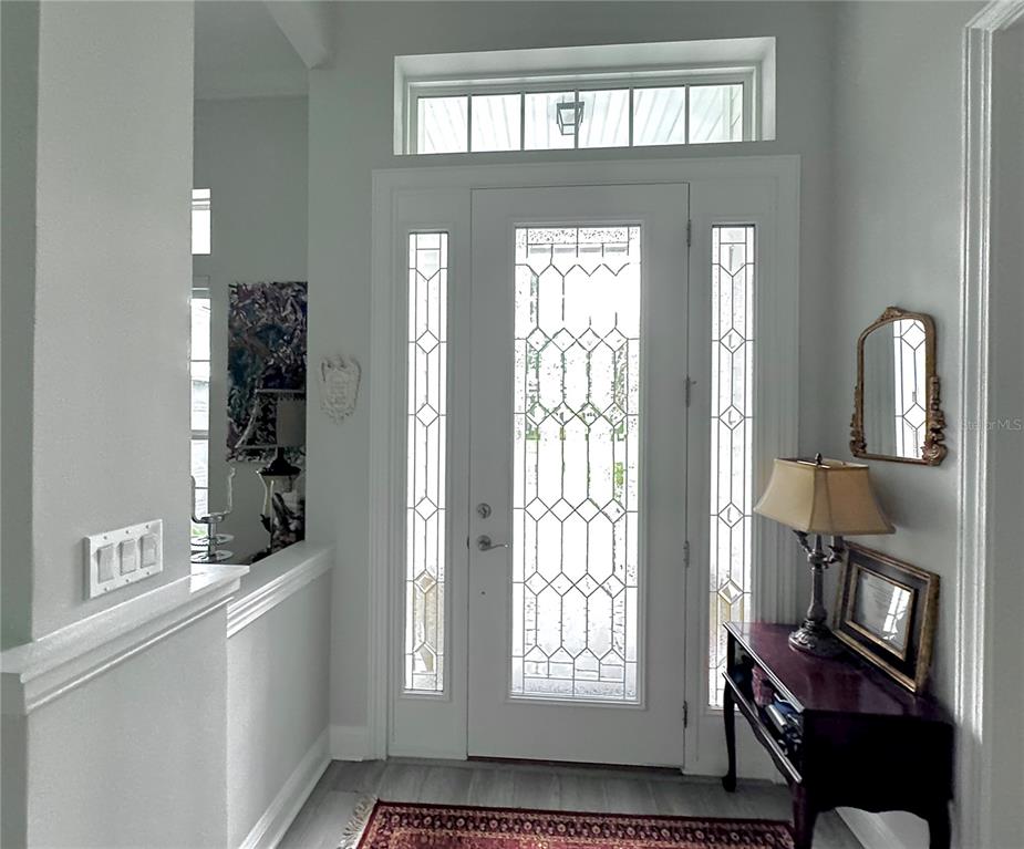 An entryway features a white front door with glass panels, sidelights, and a transom window — 862504 N HAMPTON CLUB WAY, FERNANDINA BEACH, FL