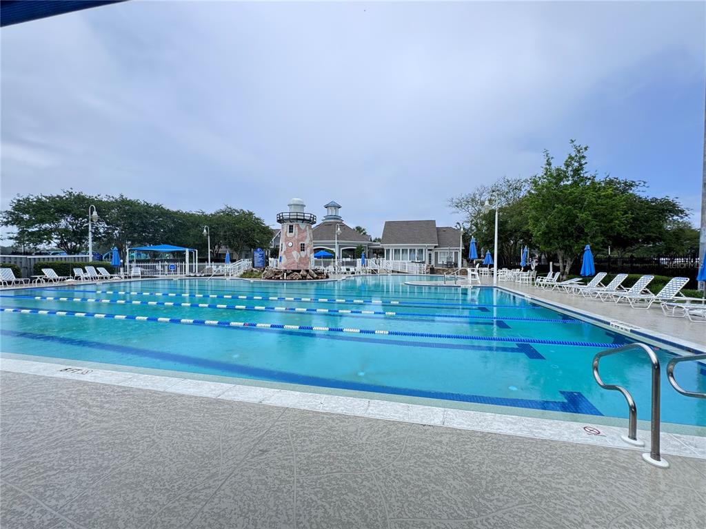 A large outdoor swimming pool with lap lanes and a decorative lighthouse feature — 862504 N HAMPTON CLUB WAY, FERNANDINA BEACH, FL