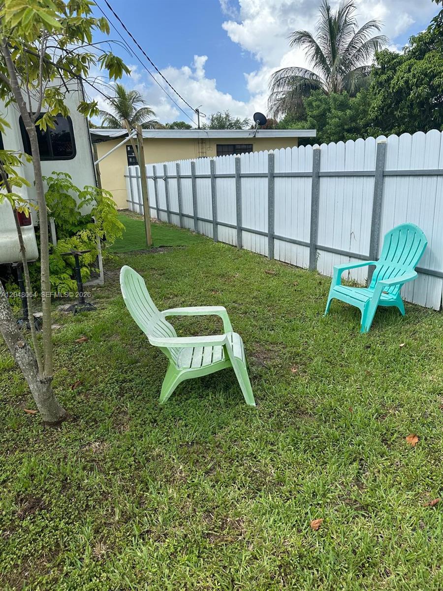 A view of a recreational vehicle interior featuring wood cabinetry, a refrigerator, and flooring — 655 NW 152nd St # 655, Miami FL 33169, MIAMI, FL