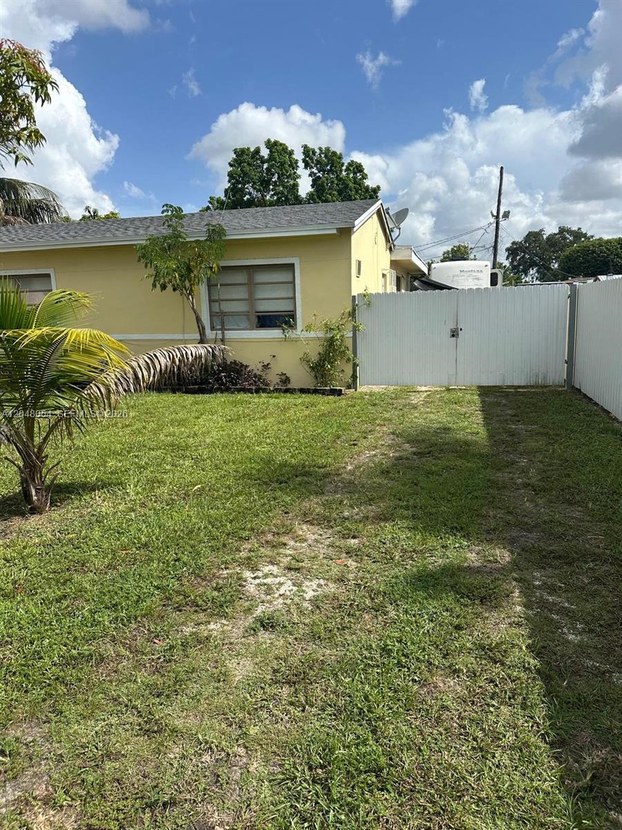 A wooden table sits in an RV dining area with wood-look flooring and pleated blinds — 655 NW 152nd St # 655, Miami FL 33169, MIAMI, FL