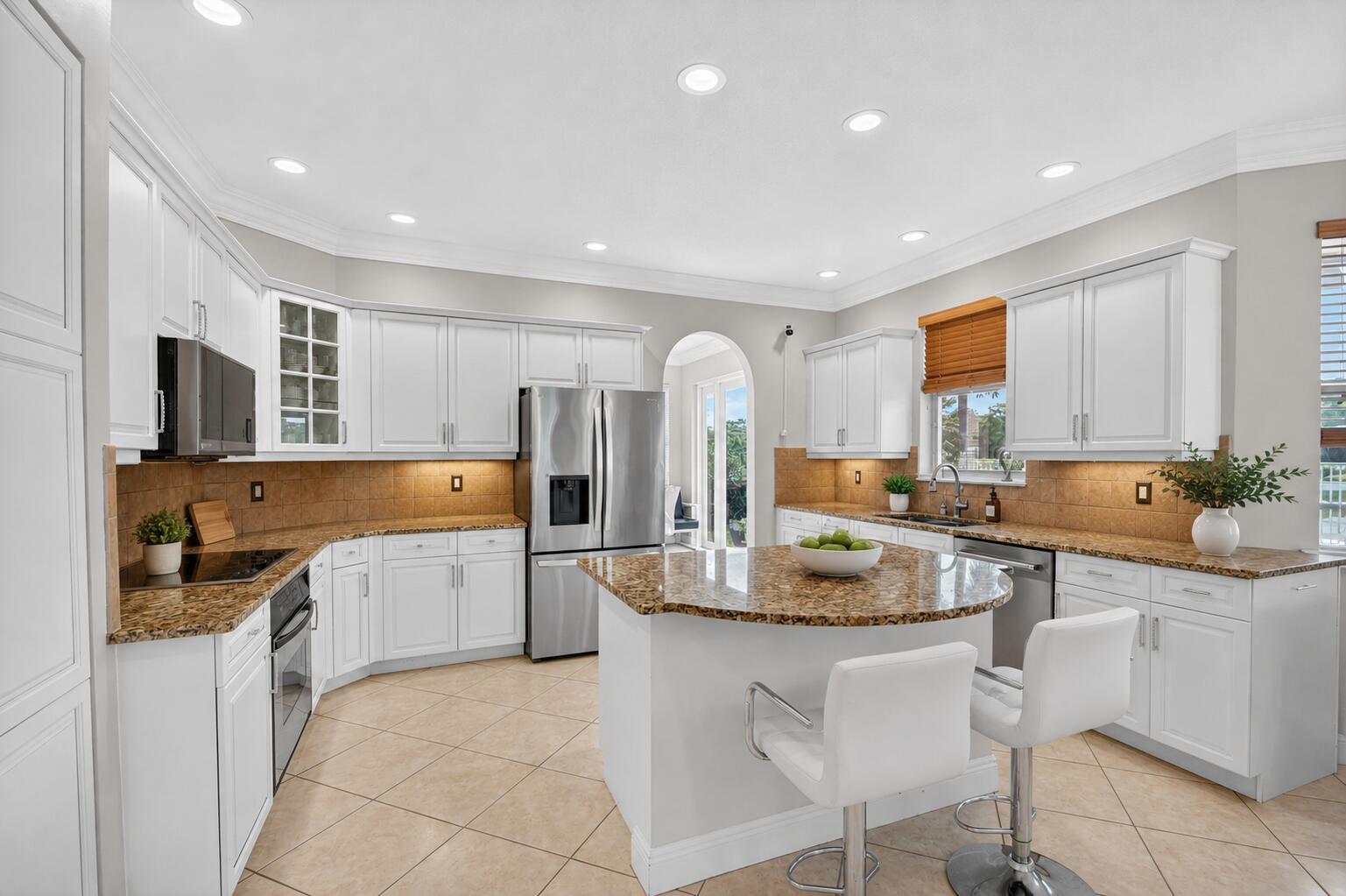 A kitchen with white cabinets, granite countertops, stainless steel appliances, and a central island — 2214 Ridgewood Circle, Royal Palm Beach FL 33411, ROYAL PALM BEACH, FL