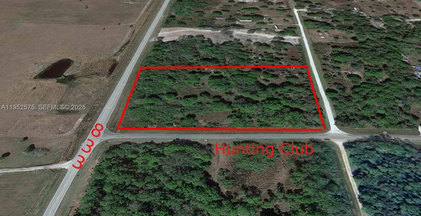 This aerial view shows a rectangular plot of land outlined in red near a road — 103 Hunting Club AVE, Clewiston FL 33440, CLEWISTON, FL