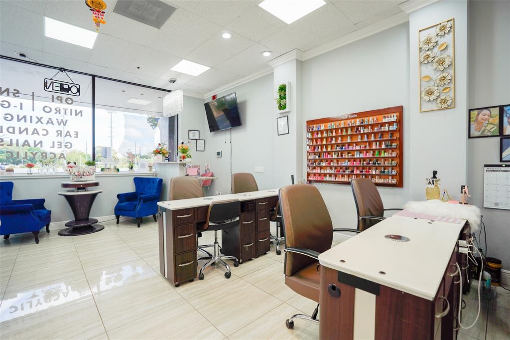 This nail salon features multiple manicure stations, a wall-mounted polish display, and blue armchairs — 865 FL-436, CASSELBERRY, FL