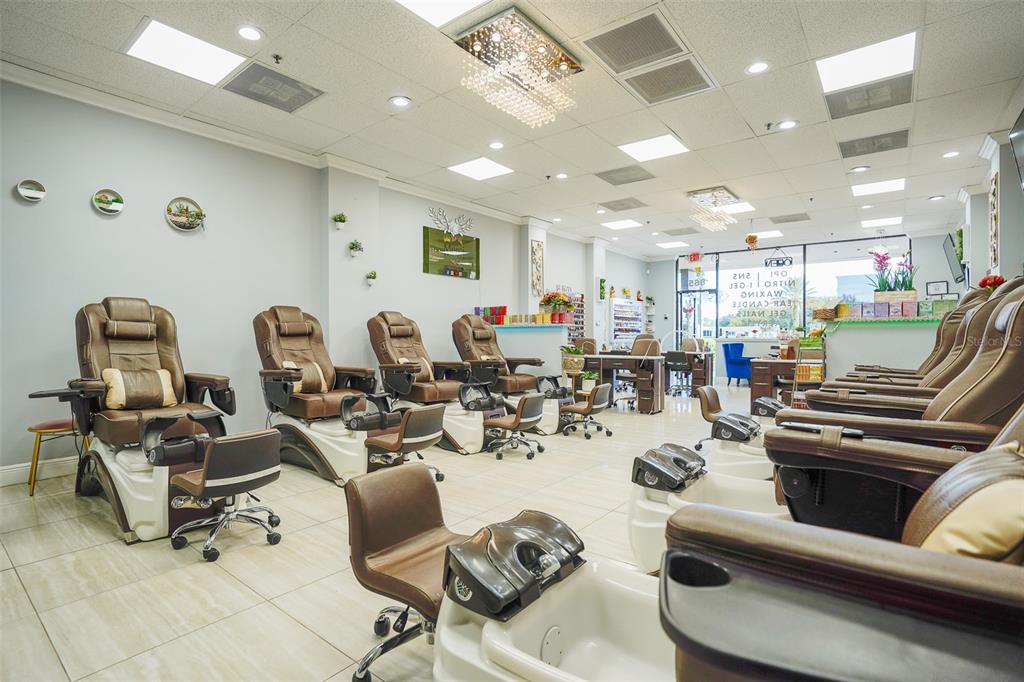 A nail salon interior features multiple pedicure chairs, tile flooring, and recessed lighting — 865 FL-436, CASSELBERRY, FL