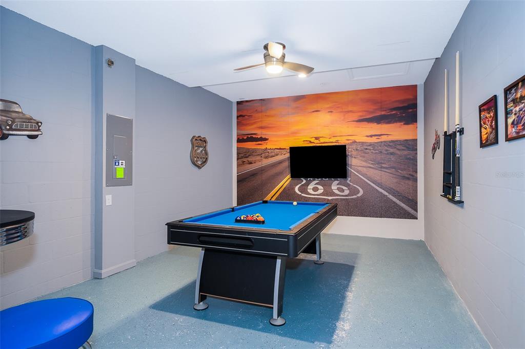 A game room features a pool table, a Route 66 wall mural, and a ceiling fan — 817 OCEAN COURSE AVENUE UNIT 817, DAVENPORT, FL