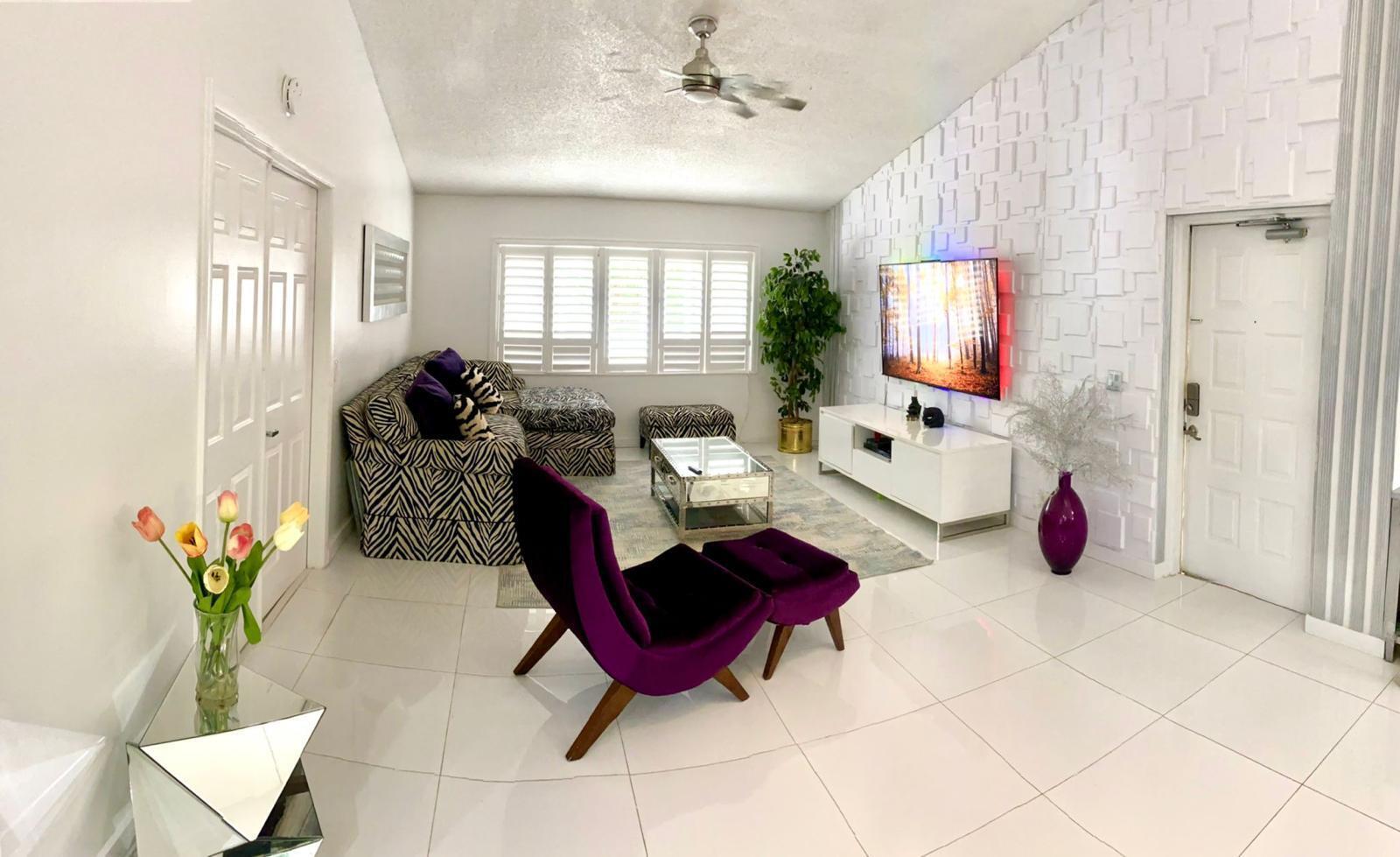 A living room features white tile floors, a zebra-print sectional, and a purple accent chair — 13770 Oneida Drive # B2, Delray Beach FL 33446, DELRAY BEACH, FL