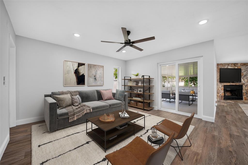 A living room features a gray sofa, two leather chairs, a coffee table, and sliding doors — 12100 CAROLINA WOODS LANE, ORLANDO, FL
