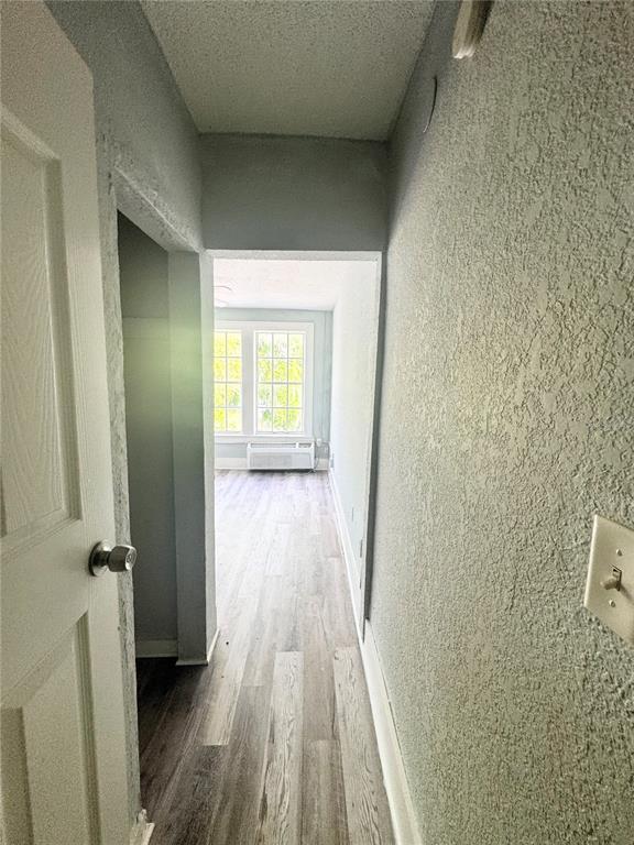 A view through a doorway into a room with light wood-look flooring and windows — 704 CORDOVA DRIVE UNIT 6, ORLANDO, FL