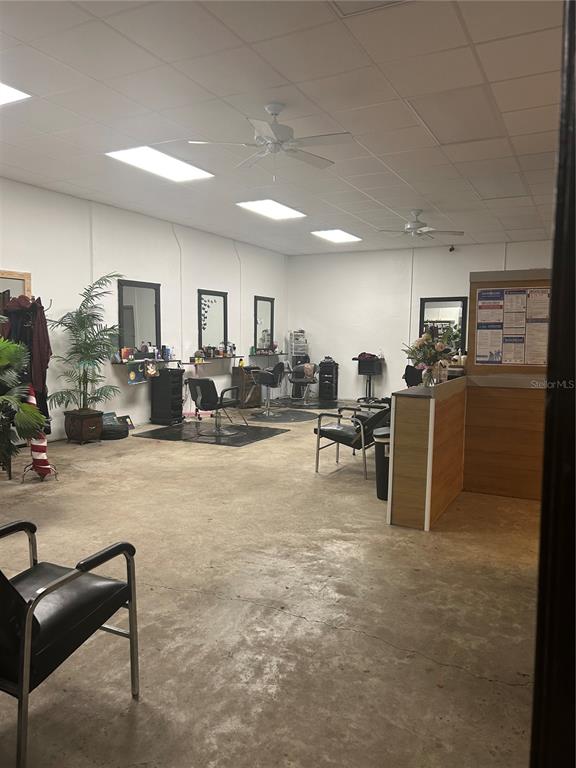 An interior view of a hair salon featuring multiple styling stations, mirrors, and concrete flooring — 1605 N TEMPLE AVENUE, STARKE, FL