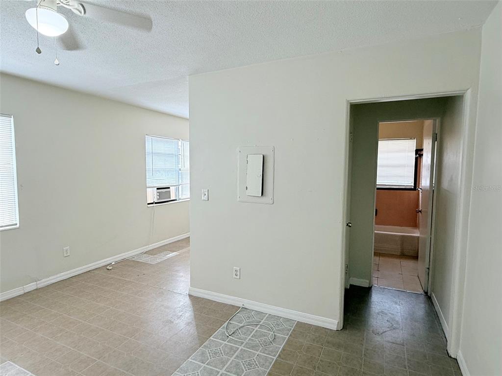 An interior view shows a room with tile flooring, a ceiling fan, and a doorway — 2404 10TH STREET W UNIT 1, BRADENTON, FL