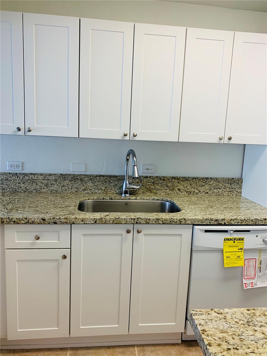 A kitchen features white shaker cabinets, granite countertops, a stainless steel sink, and a dishwasher — 6900 N Kendall Dr # A304, Pinecrest FL 33156, PINECREST, FL