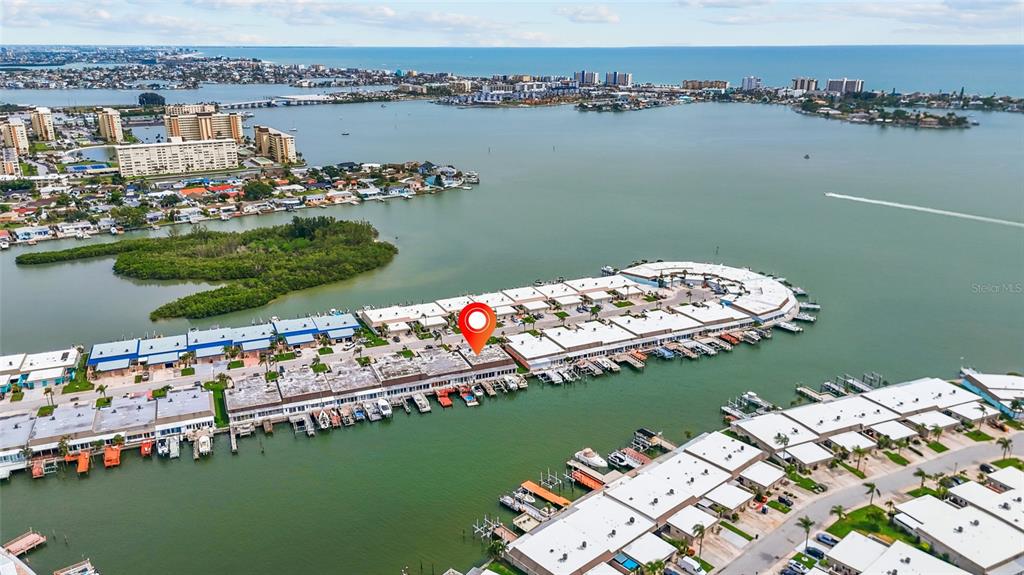 An aerial view shows a waterfront residential complex with boat slips and a red location marker — 531 BOCA CIEGA POINT BOULEVARD S UNIT 531, ST PETERSBURG, FL