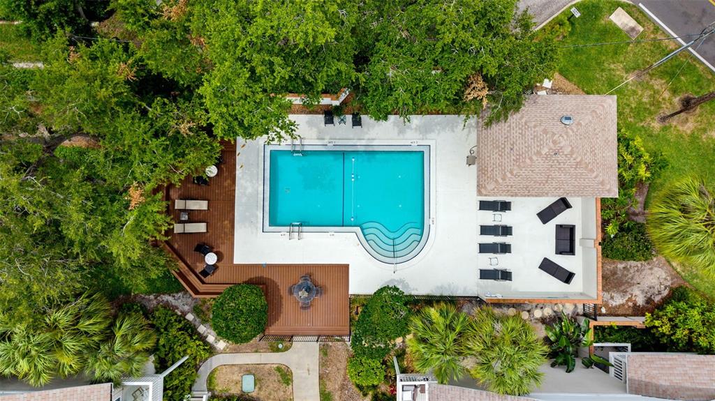 An aerial view shows a rectangular swimming pool with a sun deck, lounge chairs, and gazebo — 2605 W BALLAST POINT BOULEVARD, TAMPA, FL