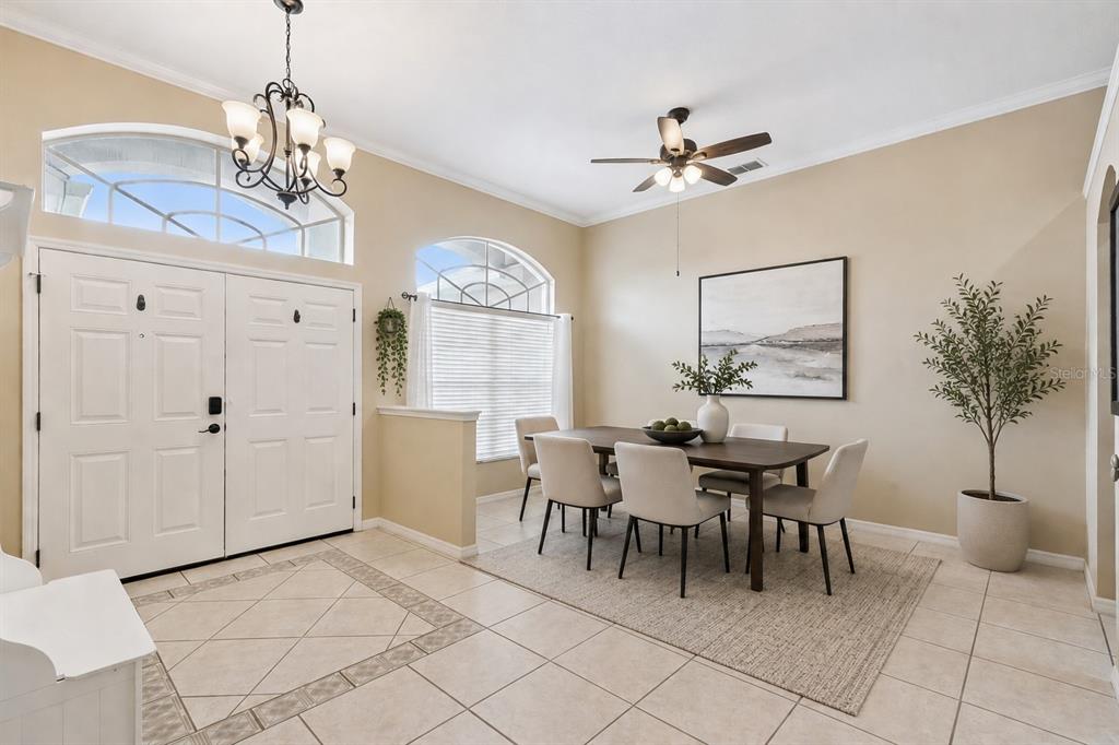 A dining area features a wooden table with six chairs, tile flooring, and arched windows — 13429 FALCON POINTE DRIVE, ORLANDO, FL