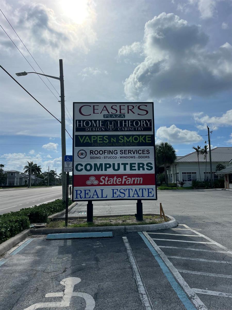 A multi-tenant business plaza sign stands in a parking lot under a cloudy sky — 836 W Indiantown Road, Jupiter FL 33458, JUPITER, FL