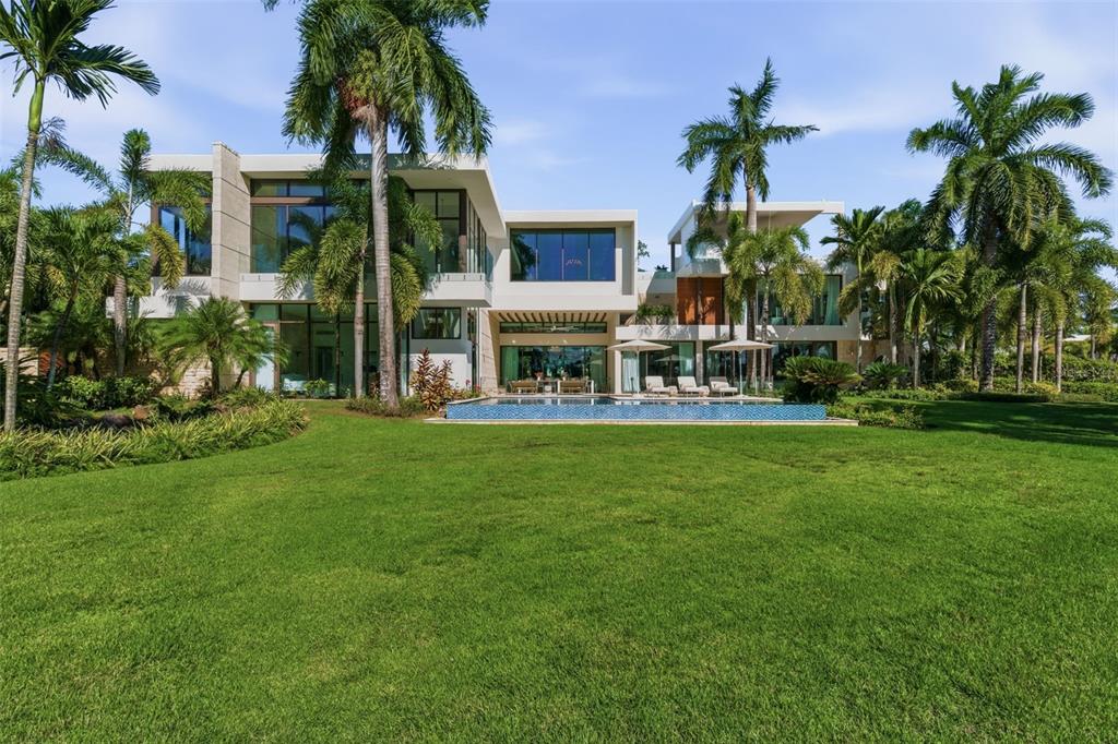 A modern two-story house with a swimming pool and palm trees in a large yard — 200 DORADO BEACH DRIVE UNIT 2210, DORADO, PR