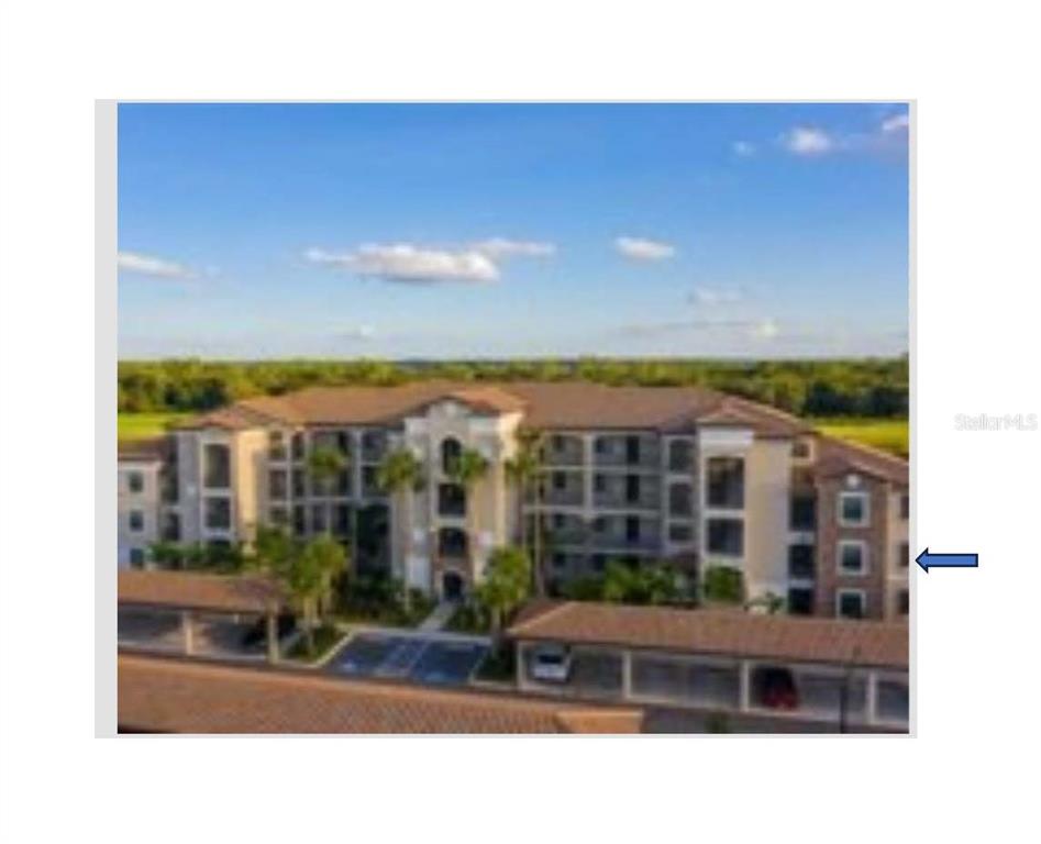 An aerial view shows apartment buildings, a swimming pool, and a golf course beside water — 16706 VARDON TERRACE UNIT 208, LAKEWOOD RANCH, FL