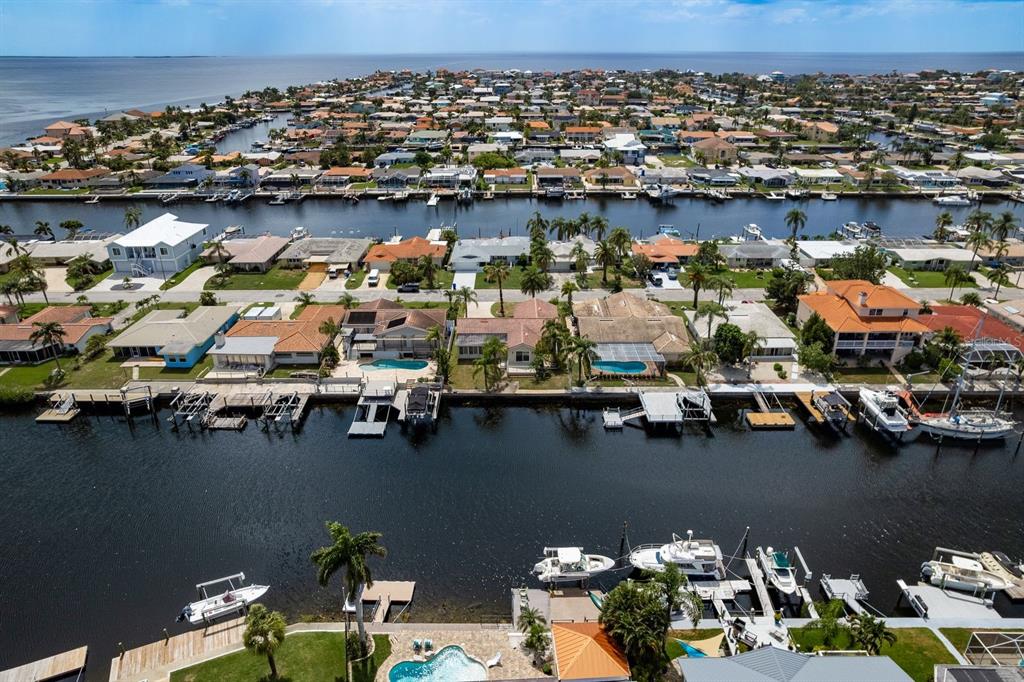 Aerial view of waterfront houses with private docks and boats along a canal — 5008 GLENN DRIVE, NEW PORT RICHEY, FL