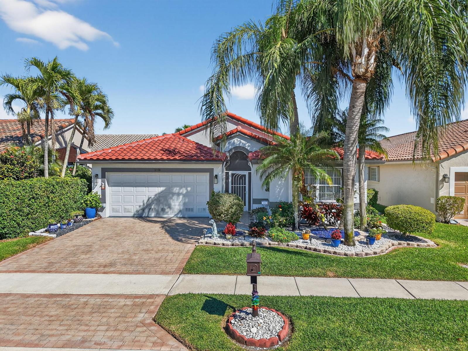 A single-story house with a red tile roof, brick driveway, and palm trees in front — 11550 Ballylee Terrace, Boynton Beach FL 33437, BOYNTON BEACH, FL