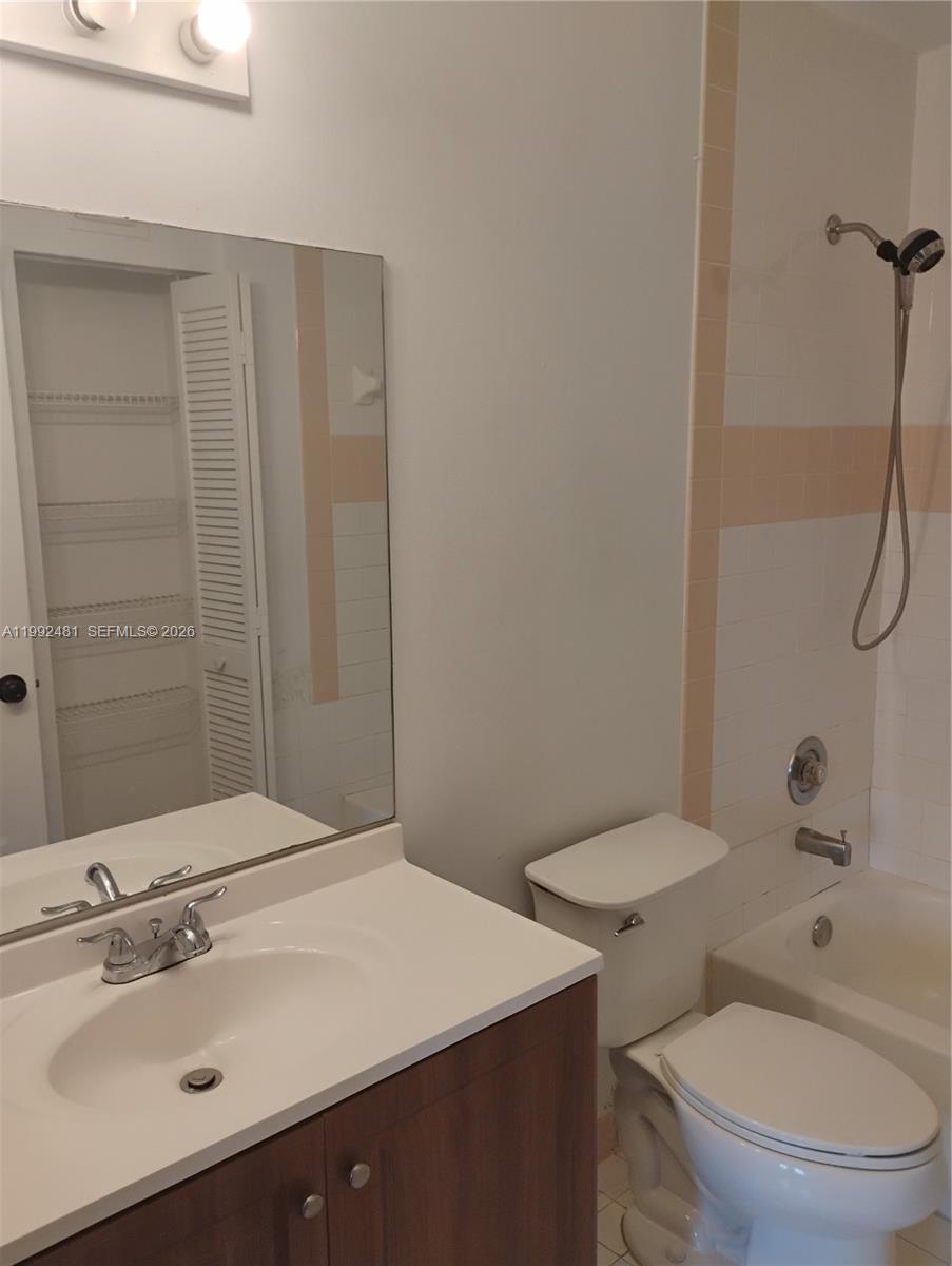 A bathroom features a vanity with a white countertop, a toilet, and a shower-tub combo — 3748 NW 91st Ln # 3748, Sunrise FL 33351, SUNRISE, FL