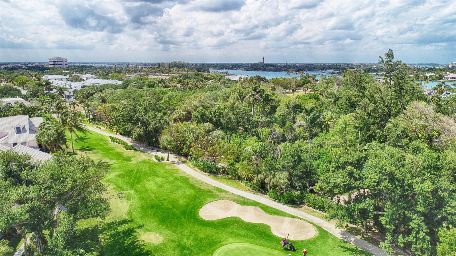 An aerial view shows a golf course fairway with a sand bunker and a lighthouse — 4409 N Fairway Dr Drive N, Jupiter FL 33477, JUPITER, FL