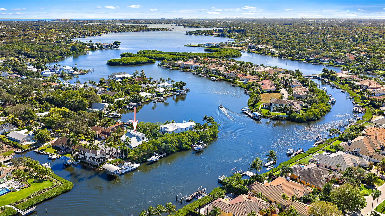 An aerial view shows waterfront homes with private docks along a winding canal — 9176 SE River Terrace, Jupiter FL 33469, JUPITER, FL