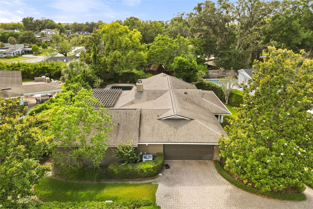 An aerial view of a single-story house with a shingled roof and a paved driveway — 119 HOLLIE COURT, MAITLAND, FL