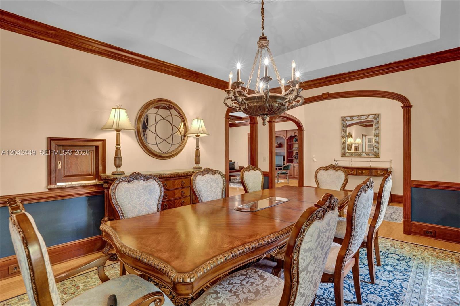A formal dining room features a large wooden table, upholstered chairs, and a crystal chandelier — 2579 Grey Rabbit Run, NC 27205, NC