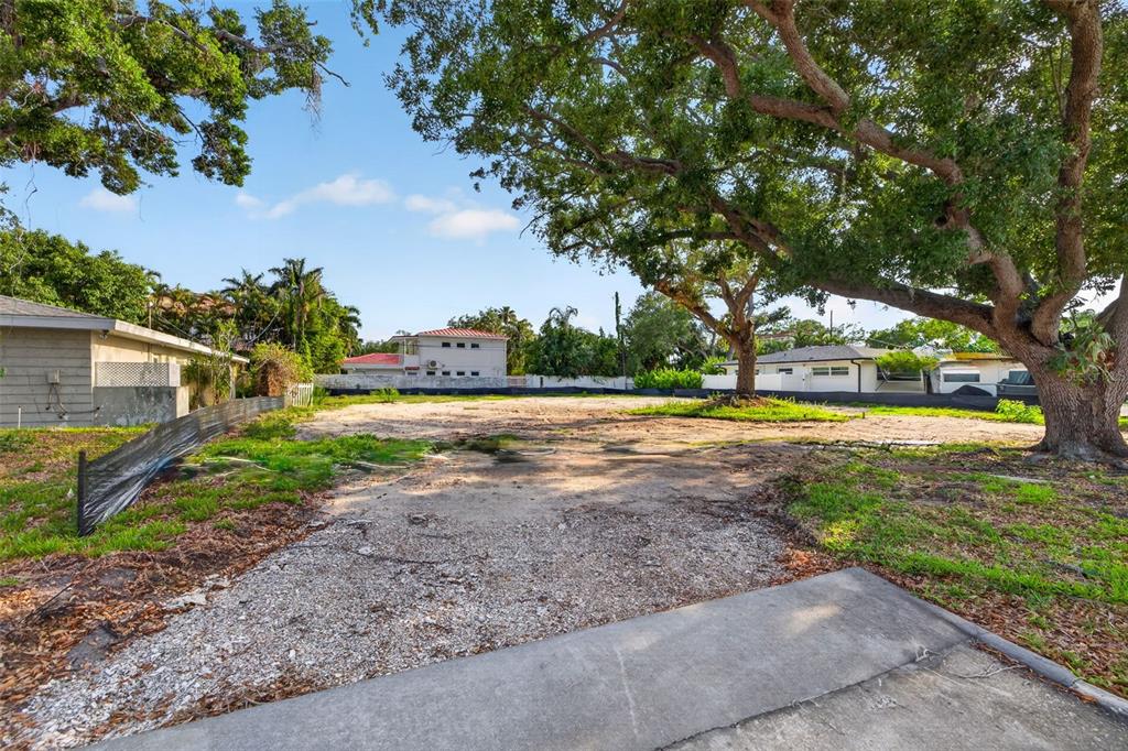 An aerial view shows a vacant residential lot outlined in yellow between two existing houses — 289 RAFAEL BOULEVARD NE, ST PETERSBURG, FL